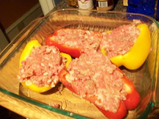 Set the oven to 350. In a bowl, mix a pound of ground beef with a half-cup cooked white rice, salt and pepper, chopped fresh garlic, an egg, and parsley, dried or fresh. Spoon the beef mixture into halved peppers. It will make at least 6 half-peppers.